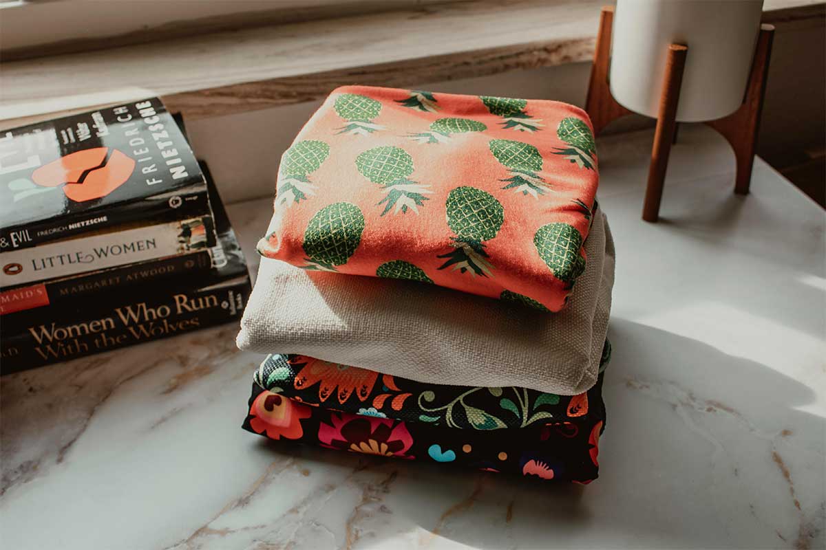 Folded thrifted finds and secondhand books — a frugal living tip for beginners is to buy second-hand first