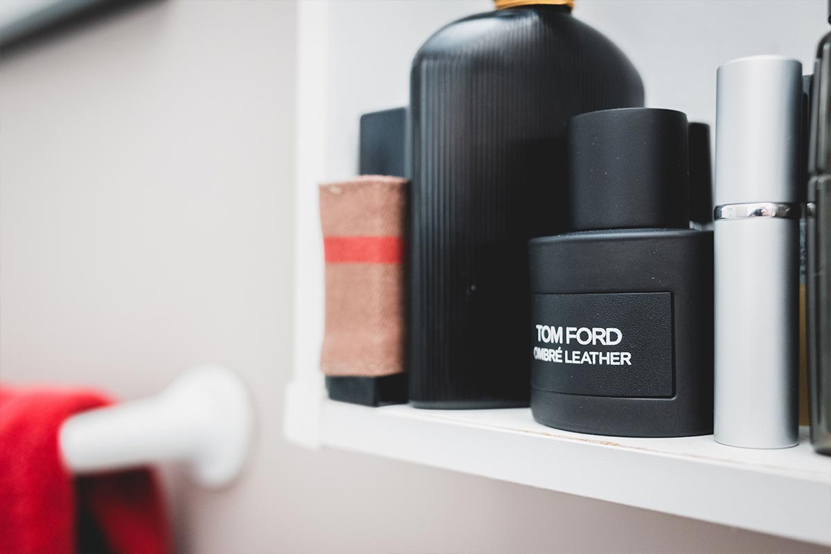 Styled bottles on a minimalist bathroom shelf — bathroom decor ideas on a budget