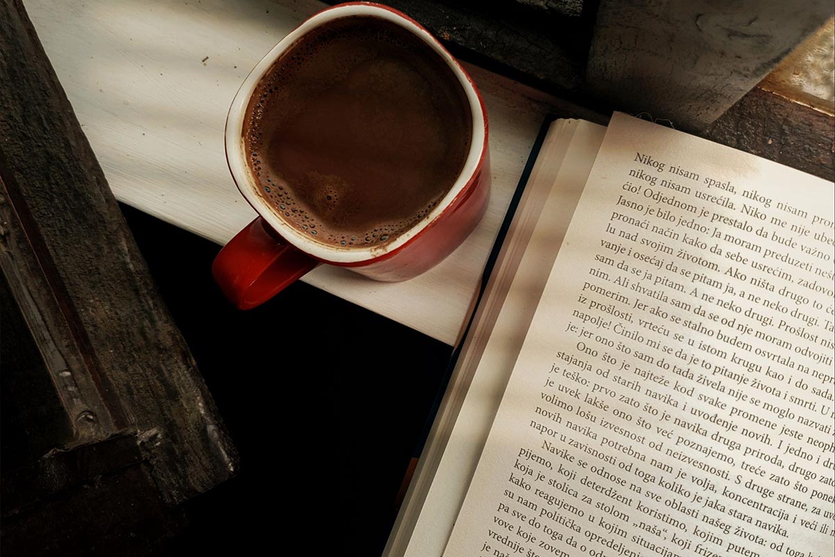 A cup of herbal tea and a candle in warm light — night routine on a budget.