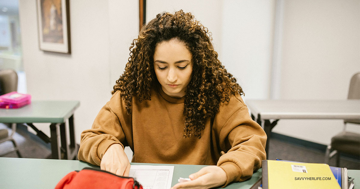 College student tracking expenses to learn how to save money every month