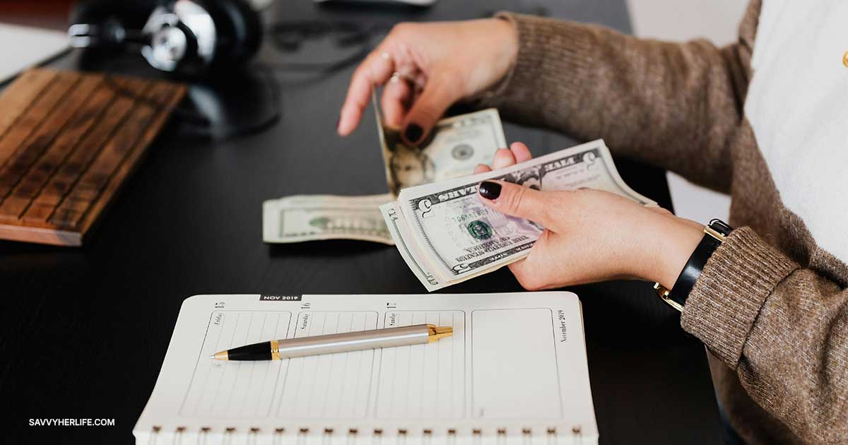 Counting cash over a planner — things to stop buying to save money every month