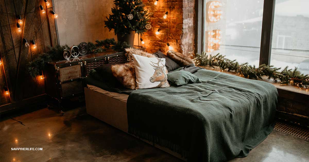 Dorm room decor on a budget — a cozy decorated college dorm bed with layered bedding, string lights, and a small rug