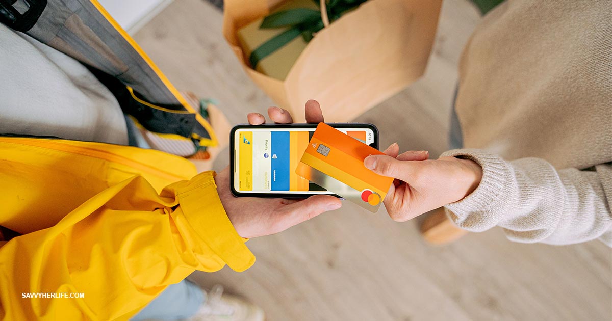 How to stop impulse buying — a phone showing an online shopping cart set face-down next to a notebook, a debit card, and a coffee on a desk