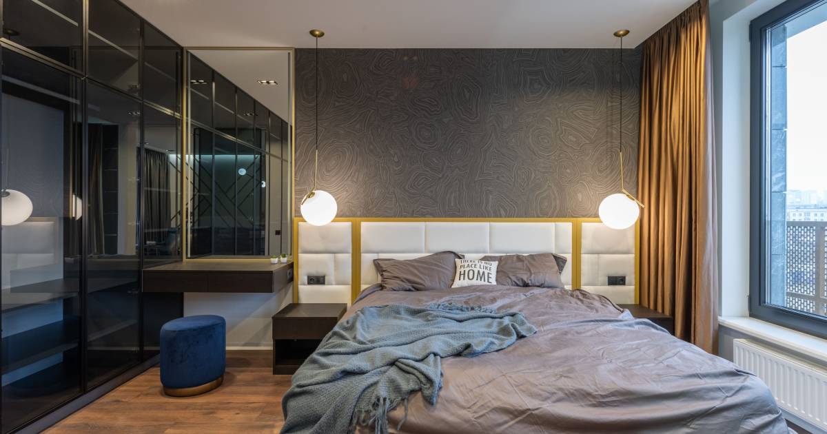 Small bedroom decor ideas on a budget — a cozy styled small bedroom with a layered bed, warm lamp lighting, a thrifted nightstand, and a plant
