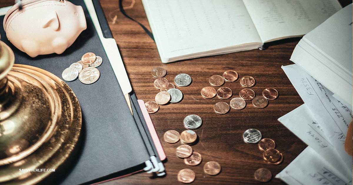 Money saving challenges — a coins and cash next to a budget notebook